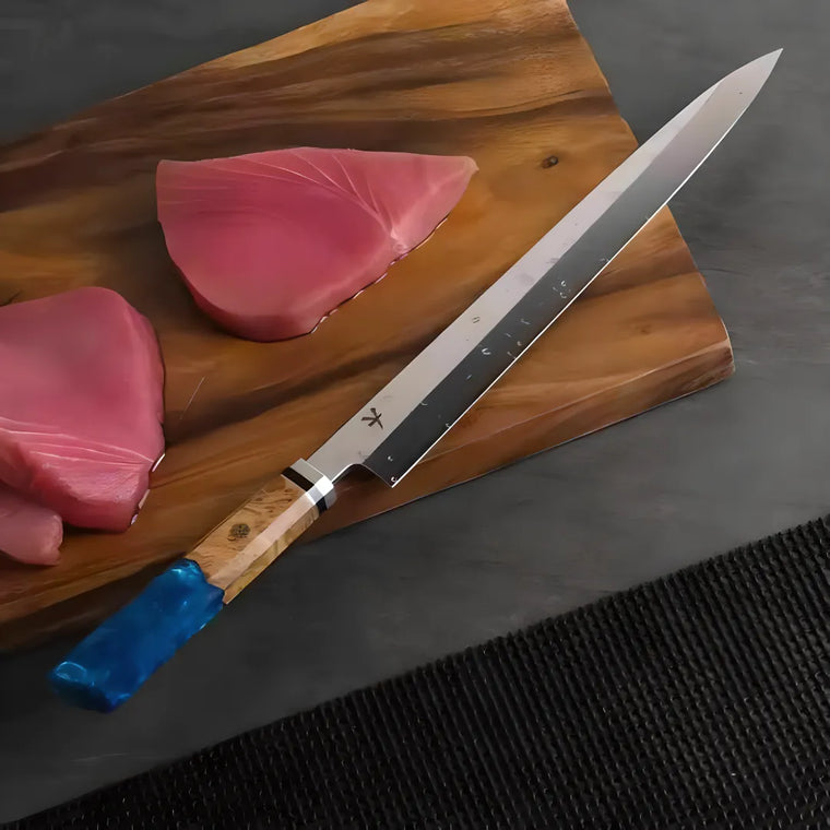 Yakushi Yanagiba making a controlled slice through fresh boneless tuna