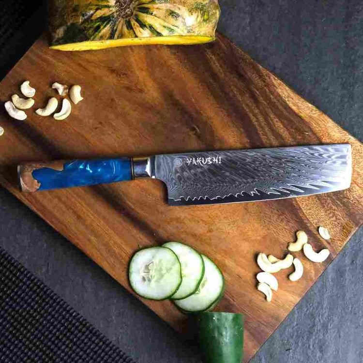 Yakushi seven-inch Damascus Nakiri vegetable knife showing its tall rectangular blade and blue resin wood handle